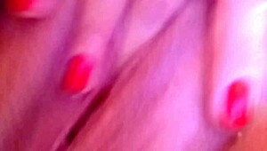 The prostitute masturbates her pink wet pussy