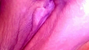 The prostitute masturbates her pink wet pussy