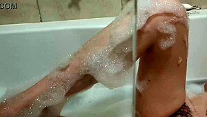 Petite amateur smokes in bath, exposing big tits and beautiful body.