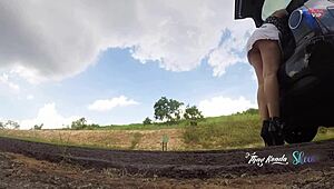 sluttish girl in short skirt flashes no panties opening car trunk on highway