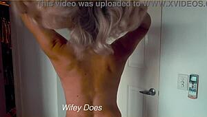 Blonde milf wife slowly strips out of tight denim shorts for homemade tease. Her big tits steal the show!