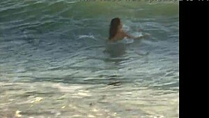 Naked girl bent over on the public beach today.