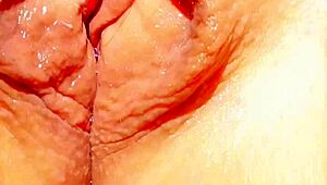 mature woman shows off her big wet vulva in close-up under skirt