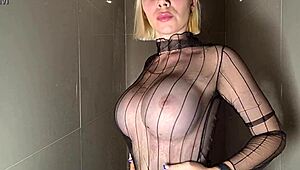 Stunning beauty flaunts huge tits under steamy shower water.