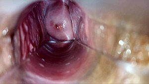 horny woman uses speculum for pulsating orgasm inside vagina.