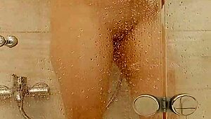 She caresses herself in the bath with big tits and ass