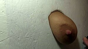 Hot Babe Fingers Herself While Sucking Cock Through Glory Hole