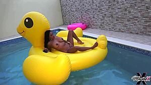 Bold Maxine X intensely plays with her wet pussy while sunbathing in the pool.