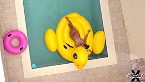 Bold Maxine X intensely plays with her wet pussy while sunbathing in the pool.