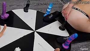 She spins the wheel of dildos to win her orgasm