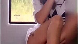 Cute girl enjoys a lollipop on the train with friends