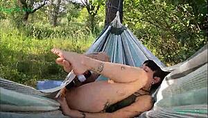 happy teen girl masturbates outdoors in a hammock in spain