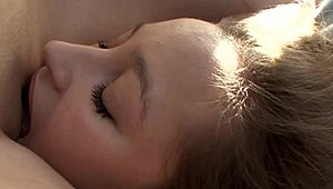 I watch two beautiful girls passionately fucking with strapon on the bed