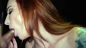 redhead inked milf deepthroats cocks at the gloryhole