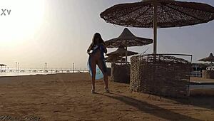 Young blonde goes pantyless on public beach