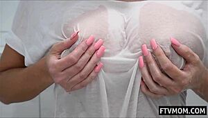 Big tits MILF bathing in the shower, displaying her huge boobs and wet body.