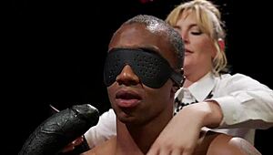 Blonde domme straps on to anal fuck and choke her bound black male slave hard!