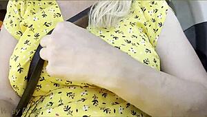 The housewife flashes her big tits in the car while driving.