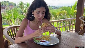 Cute girl feels excited eating burger with cum on face in public cafe