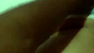 Beautiful cute woman perches on bed edge in white bra showing off huge ass against blue sky.