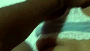 Beautiful cute woman perches on bed edge in white bra showing off huge ass against blue sky.