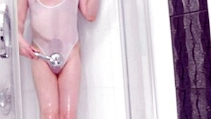 boy in see-through swimsuit plays with shower toy